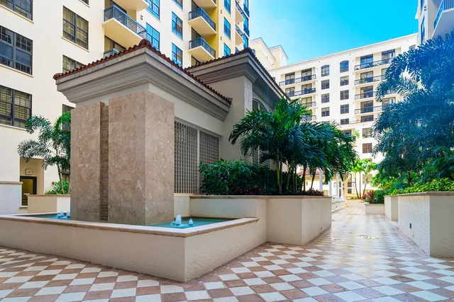 Two City Plaza — courtyard fountain and palm-lined walkway